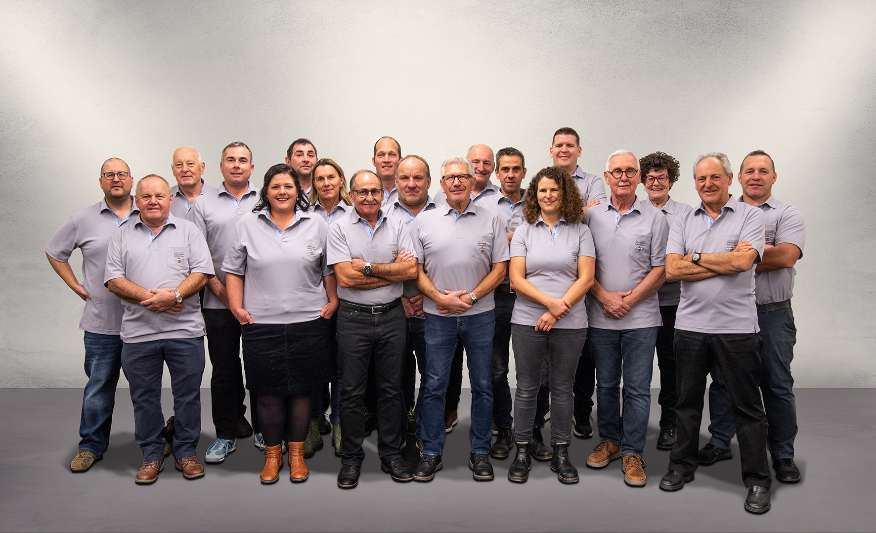 A roomy loft with deep wood floors and a matte black brick wall.
